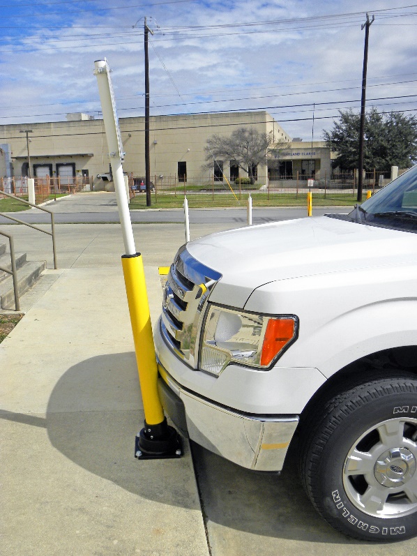 Rebounding bollard prevents white truck from entering pedestrian sidewalk